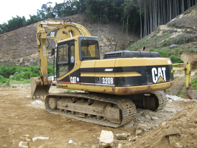 Caterpillar 320B and 320BL excavators working on a construction site.