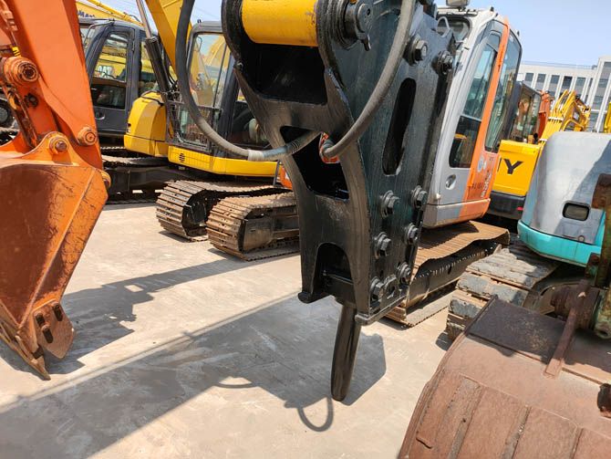 Cat 320 excavator with breaker attachment