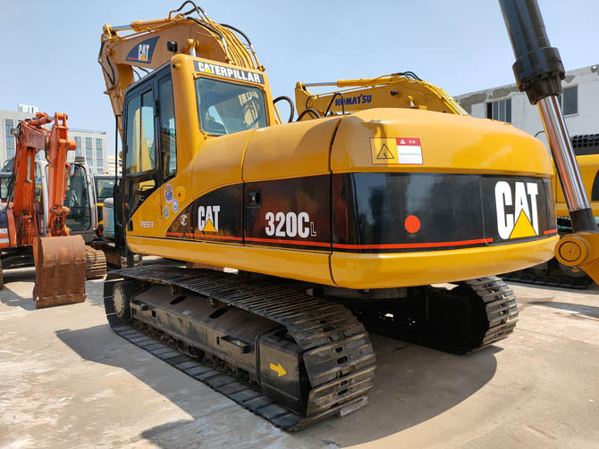 Cat 320 excavator with breaker attachment