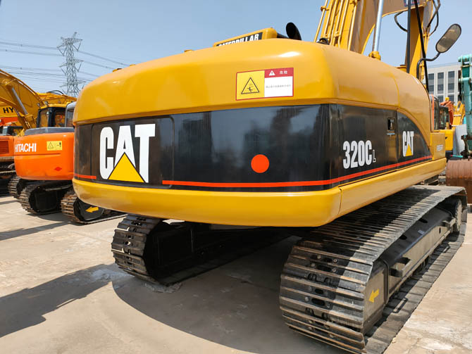 Cat 320 excavator with breaker attachment