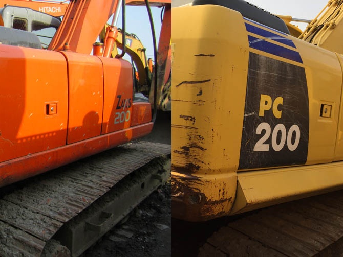 Komatsu PC200 and Hitachi ZX200 excavators side by side on construction site