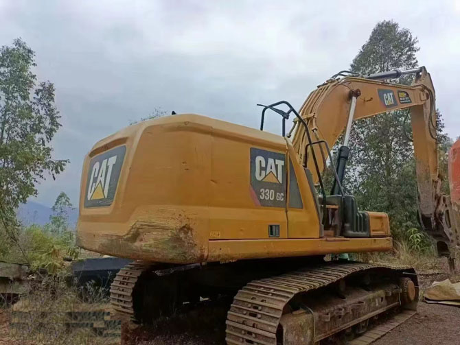 Cat 330 excavator with hydraulic breaker working on construction site