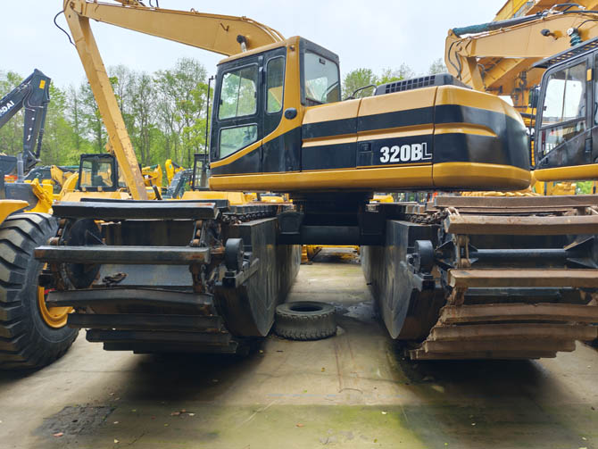 Swamp buggy Cat 320BL excavator in wetland working condition