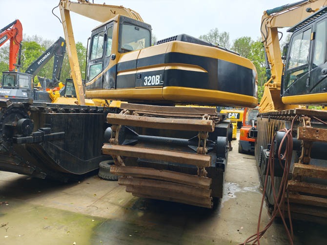 Swamp buggy Cat 320BL excavator in wetland working condition